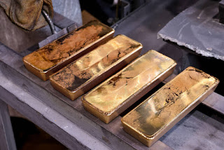Safe-haven gold near a 1-month low as global tensions ebb
